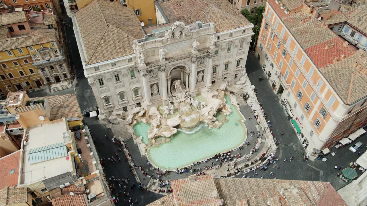 Trevi Fountain shines in heart of Rome, surrounded by historic buildings, Italy