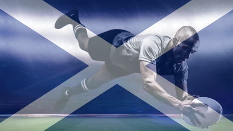 animation of flag of scotland over african american male rugby player with ball at stadium