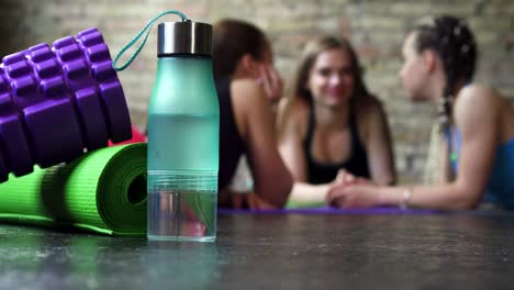 sportswomen resting after working out together at fitness studio