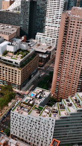 sight of the residential area on the waterfront of new york. beautifully designed buildings and sport field from aerial view. vertical video