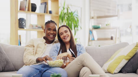 couple, popcorn and watching tv in home