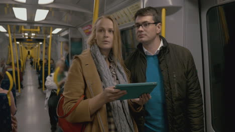 Man-And-Woman-Riding-In-The-Metro-Train