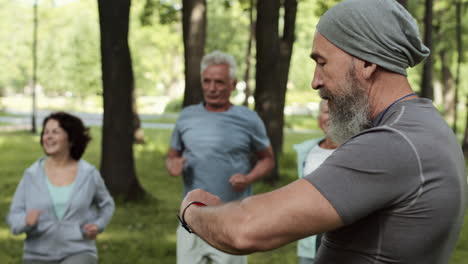 senior citizens exercising in a park