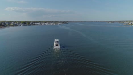 Aerial-of-a-boat-yacht-entering-a-harbor-dock-during-the-summer-time