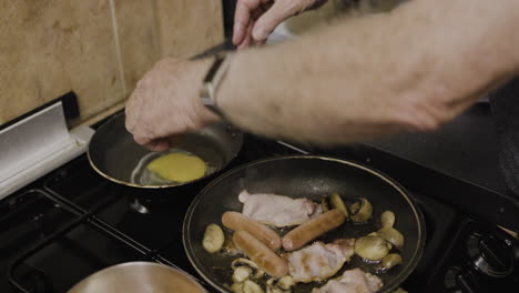 cooking breakfast with eggs, sausage, bacon, and mushrooms