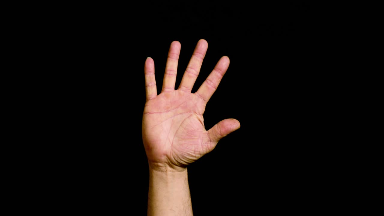 Male hand counting from number one to five on black background
