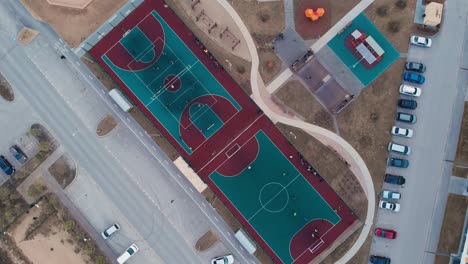 the drone takes off, circling over sports fields in the courtyard of a residential complex. courts for playing mini football, basketball and volball. preparation for competitions and olipiad