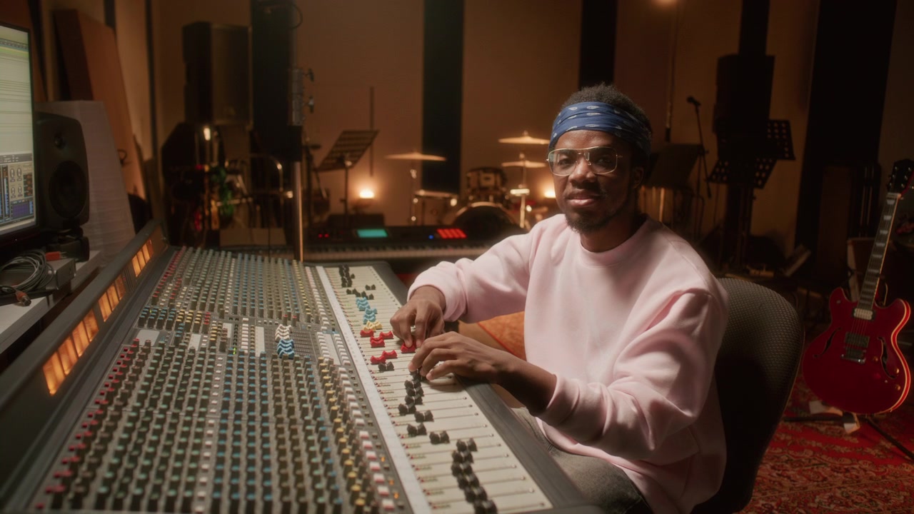Portrait of African American Audio Engineer Working in Recording Studio