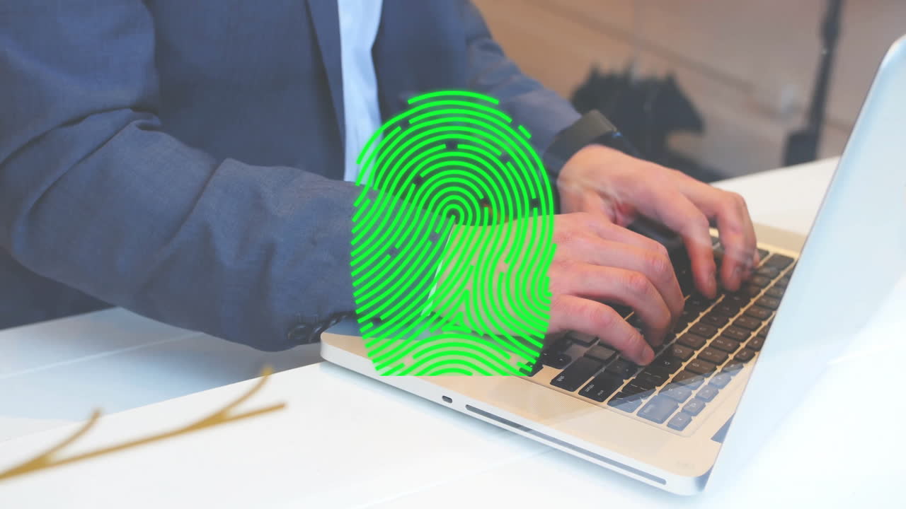 Animation of fingerprint over caucasian businessman using laptop