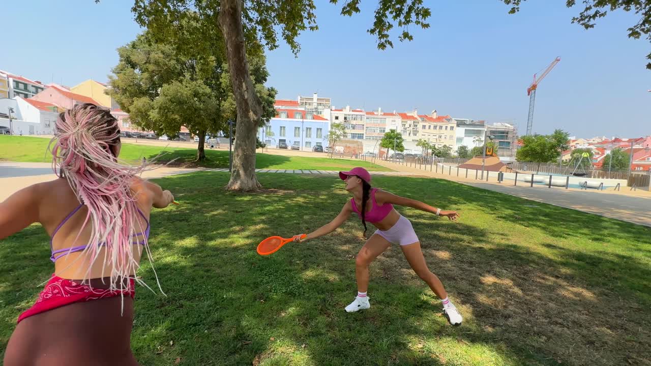 Women playing badminton in a park