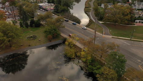 a drone shot over a reflective pond on a cloudy afternoon