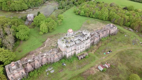 abandoned, deserted mansion estate in eerie decaying ruins, aerial