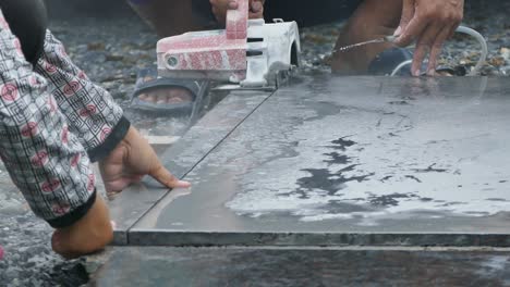 man cutting granite stone