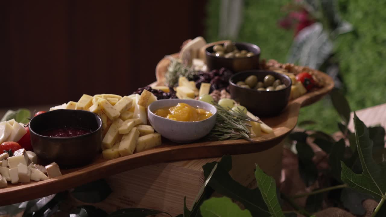 Gourmet charcuterie board with cheese, olives, nuts, and fruit spreads