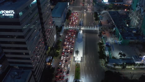 Tilting-aerial-dolly-shot-of-stopped-traffic-on-a-multi-lane-highway-at-red-light-in-Jakarta