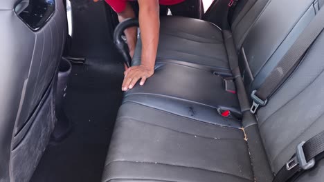 cleaning car back seat with vacuum