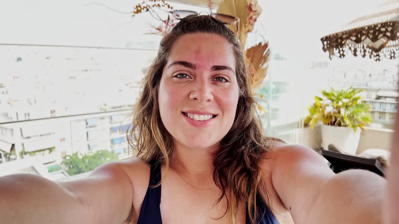 Woman taking a selfie on a balcony