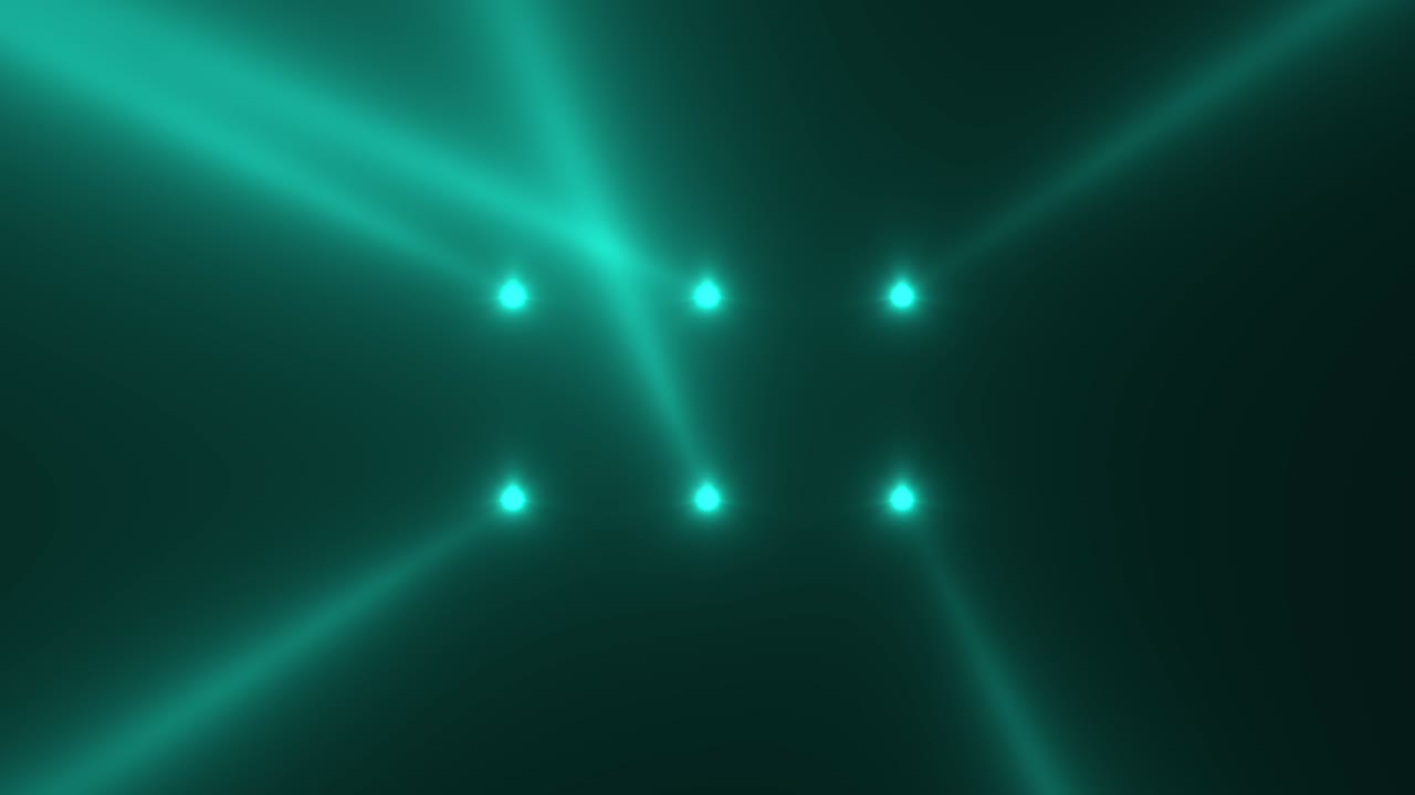 Glowing green spotlight beams on stage