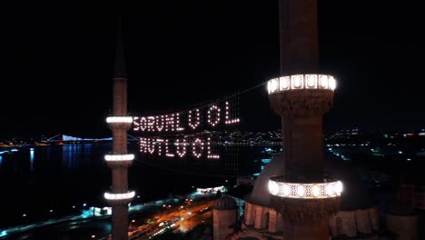 aerial night view of new mosque. there says " be responsible, be happy"