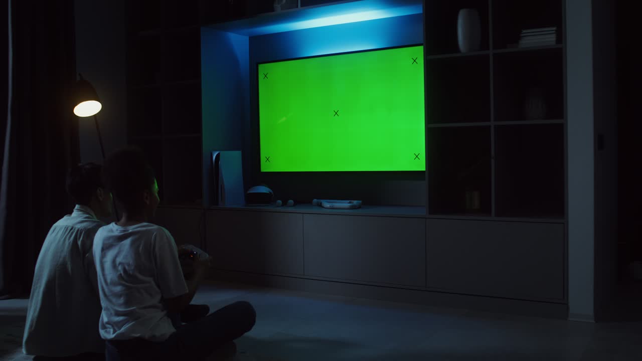 Two boys playing video games on TV