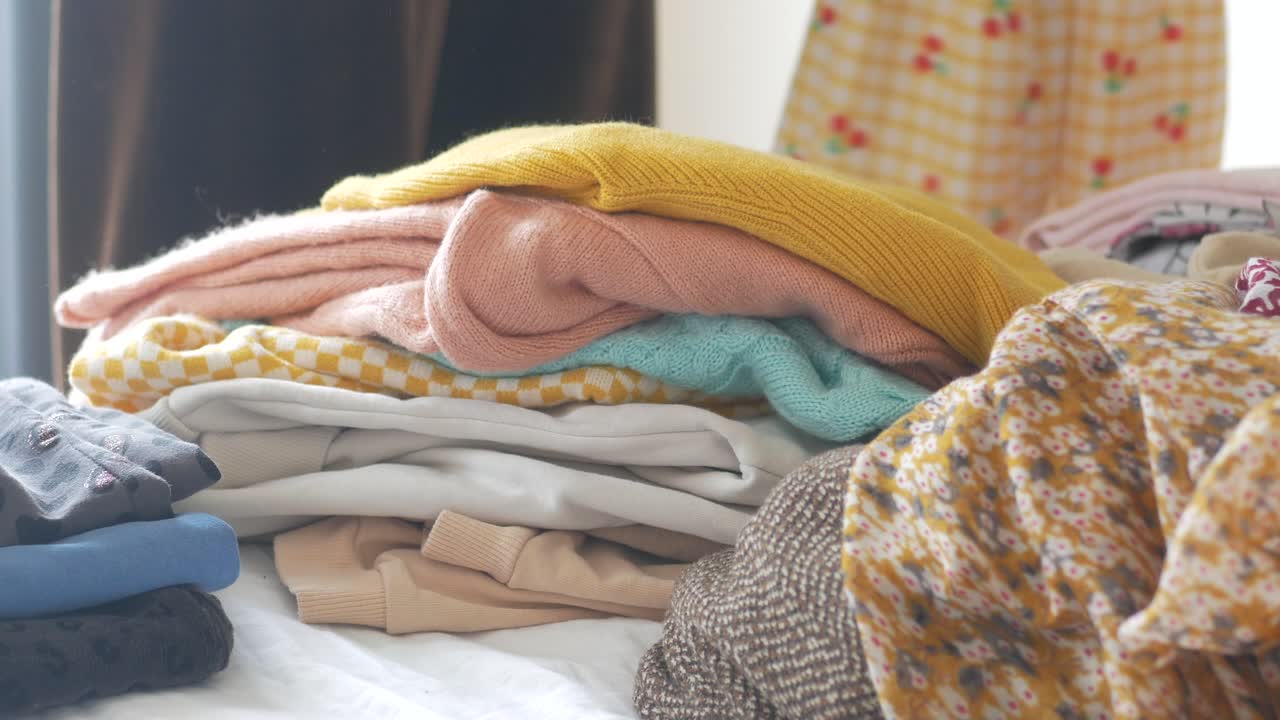 Stacked Clothes on a Bed