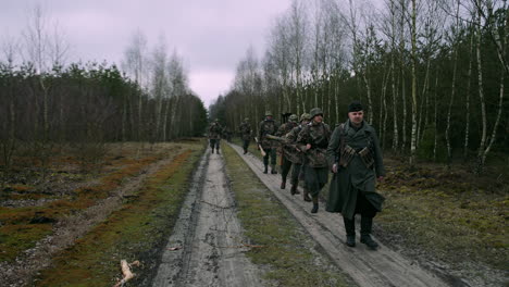 german soldiers marching through a forest