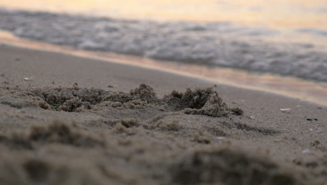 Sand-and-sea-waves-at-sunset