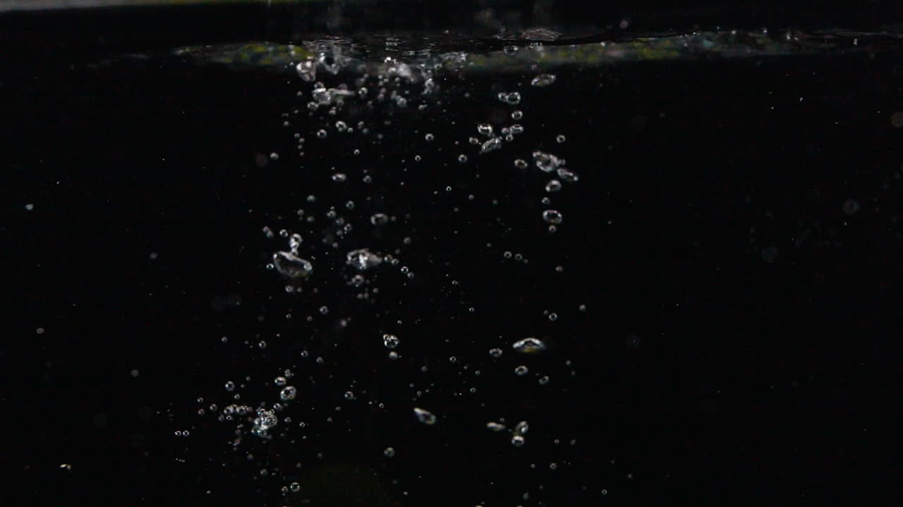Slow Motion Juicy Fresh Limes Splash in Water with Cool Bubbles