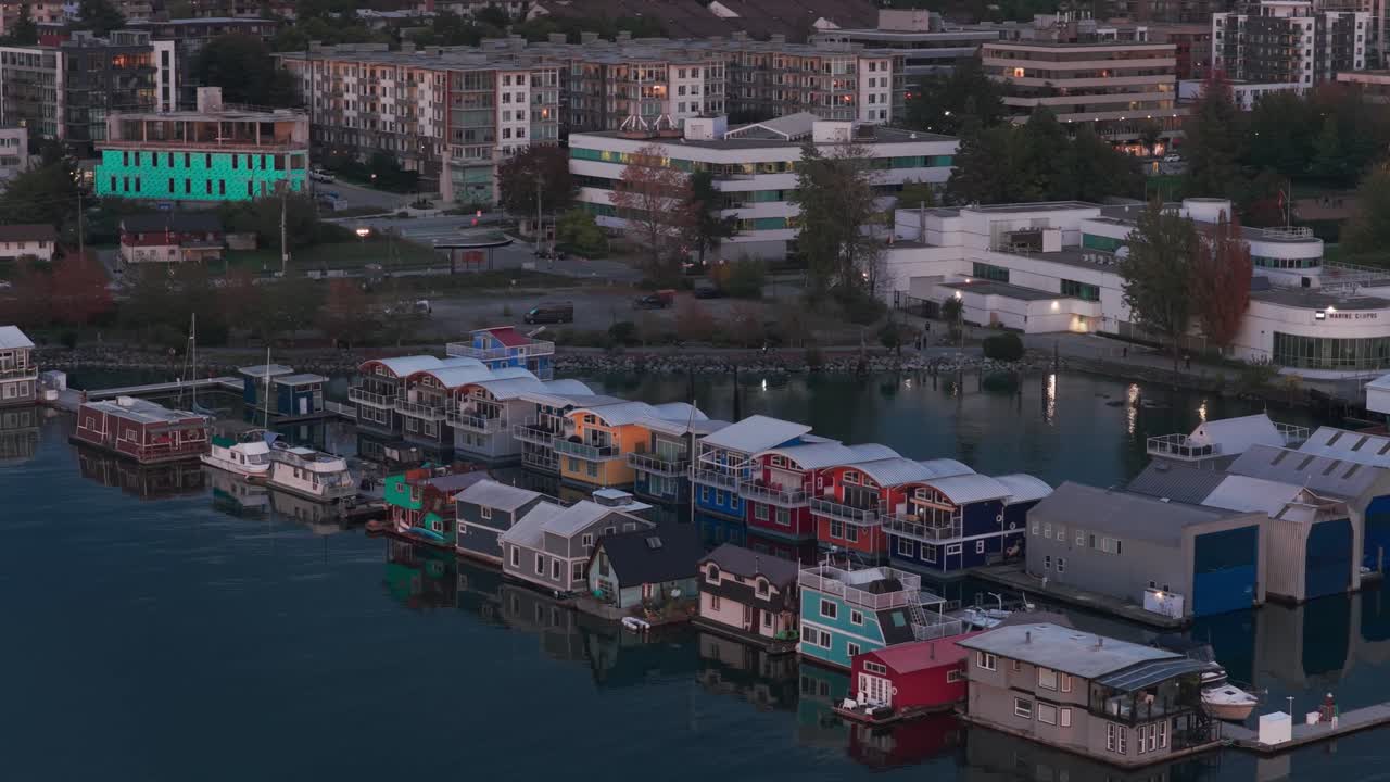 Close up aerial panning shot of floating homes at the Mosquito Creek Marina during twilight in North Vancouver, British Columbia, Canada. 4K