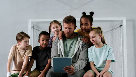 Man-and-children-at-the-soccer-field