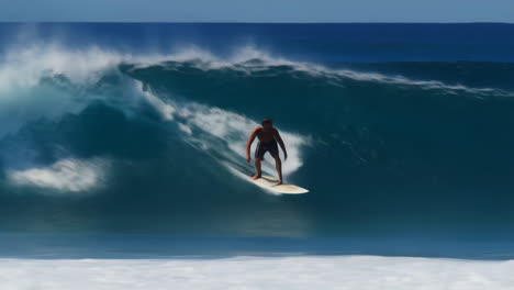 a surfer rides a large, powerful wave in the ocean