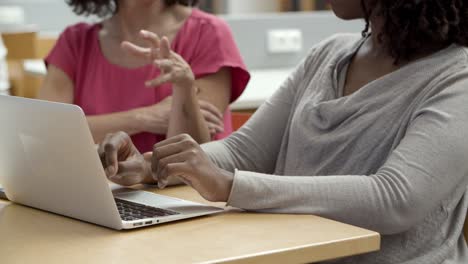 closeup shot of female hands typing on laptop