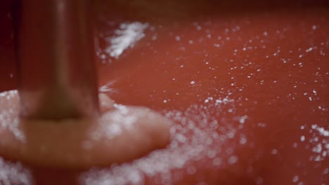 macro shot of machine mixing strawberry for sauce production