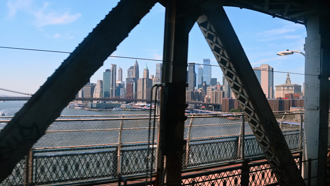 Travelling in the train by the Manhattan Bridge. View on the Brooklyn Bridge and Manhattan at backdrop