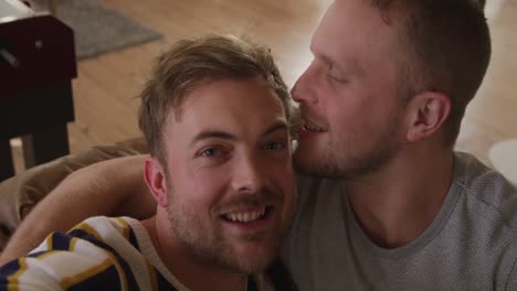 caucasian male couple in social distancing in their sofa at home