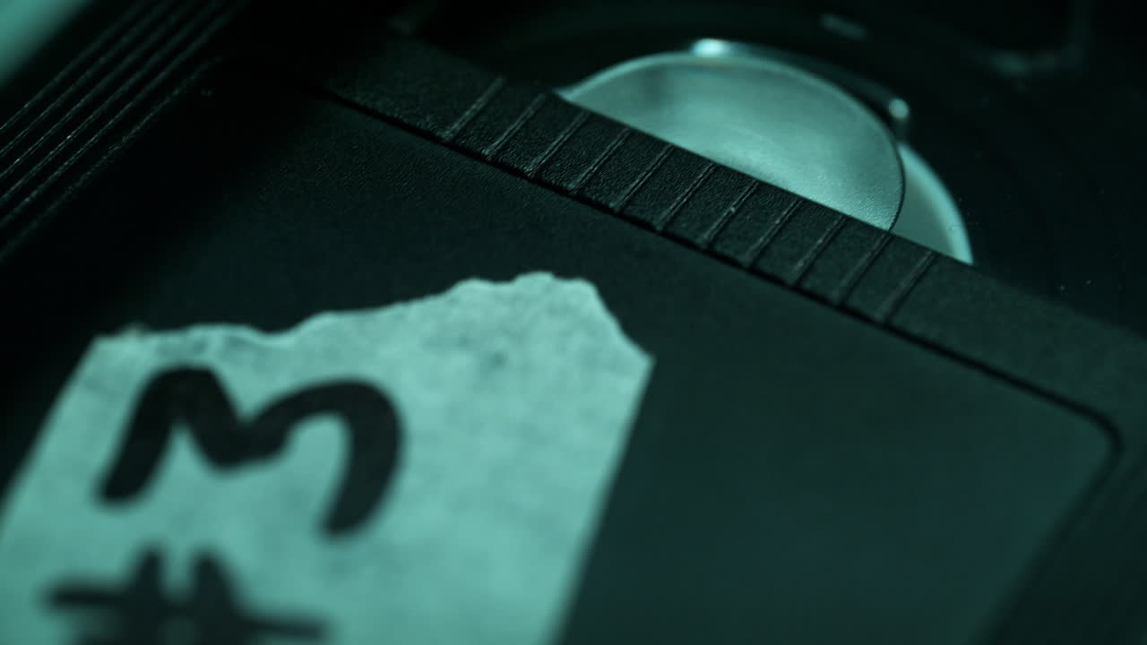Labeled Interrogation Video Cassette is Inserted into the VCR, the Tape Winds onto the Take-Up Reel - Macro