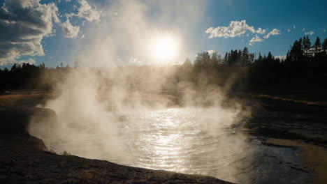 steaming hot spring in golden hour sunlight