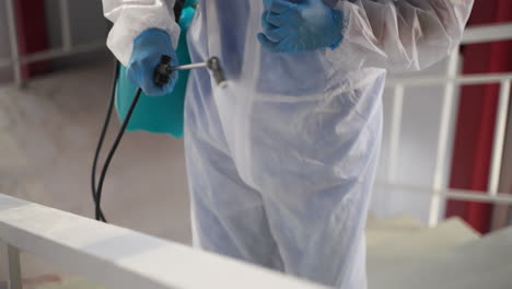 disinfection worker spraying stairs