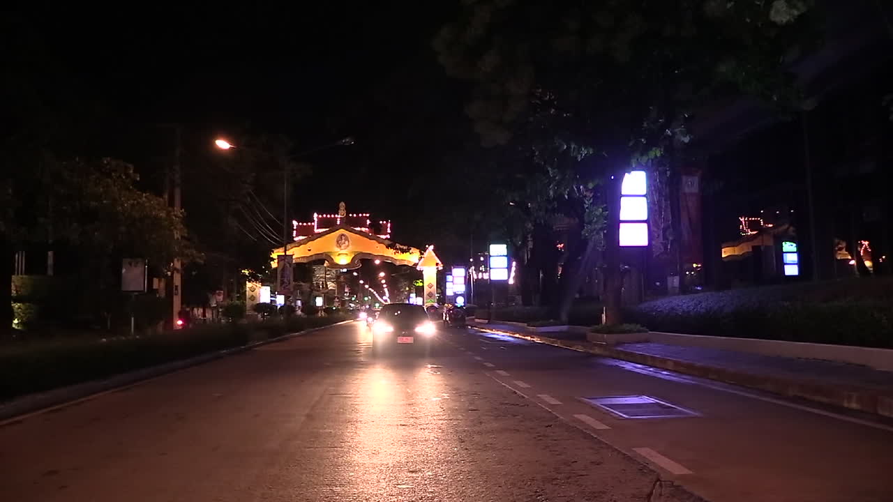view at the street and traffic from a rickshaw that's stopped in the middle of the street, Thailand