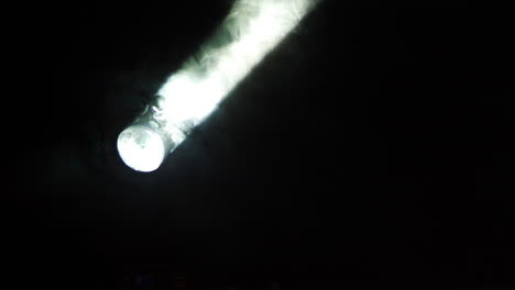 spotlight shining through smoke on stage