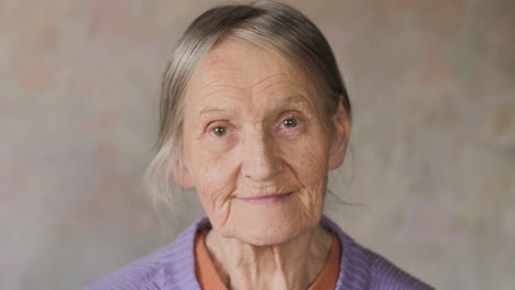 close up portrait of a happy elderly senior woman looking at camera and smiling