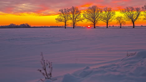 beautiful picturesque winter landscape with sunrise and colorful sky - sunlight reflection on snowy surface