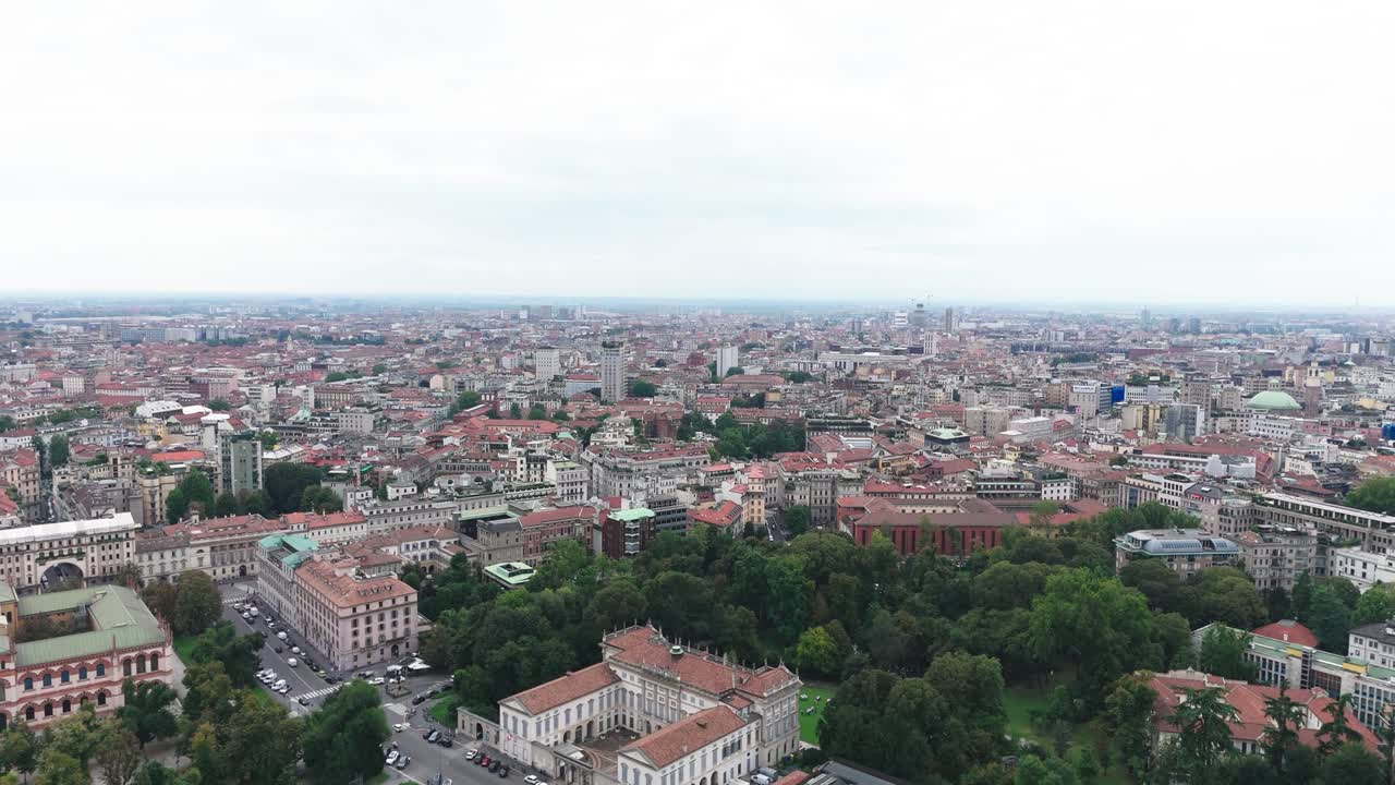 Drone view of Giardini Indro Montanelli Park and Milan, cloudy day