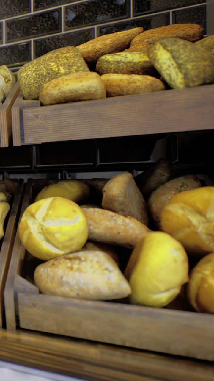 Fresh baked bread displayed in wooden baskets at a bakery shop