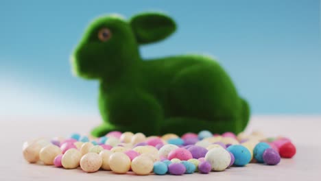 video of decorated colorful easter eggs with bunny on a wooden surface