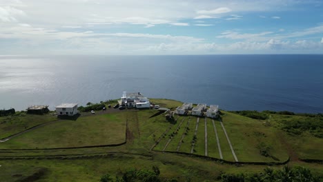 condo homes at end of dirt path look over scenic ocean view expanse on horizon