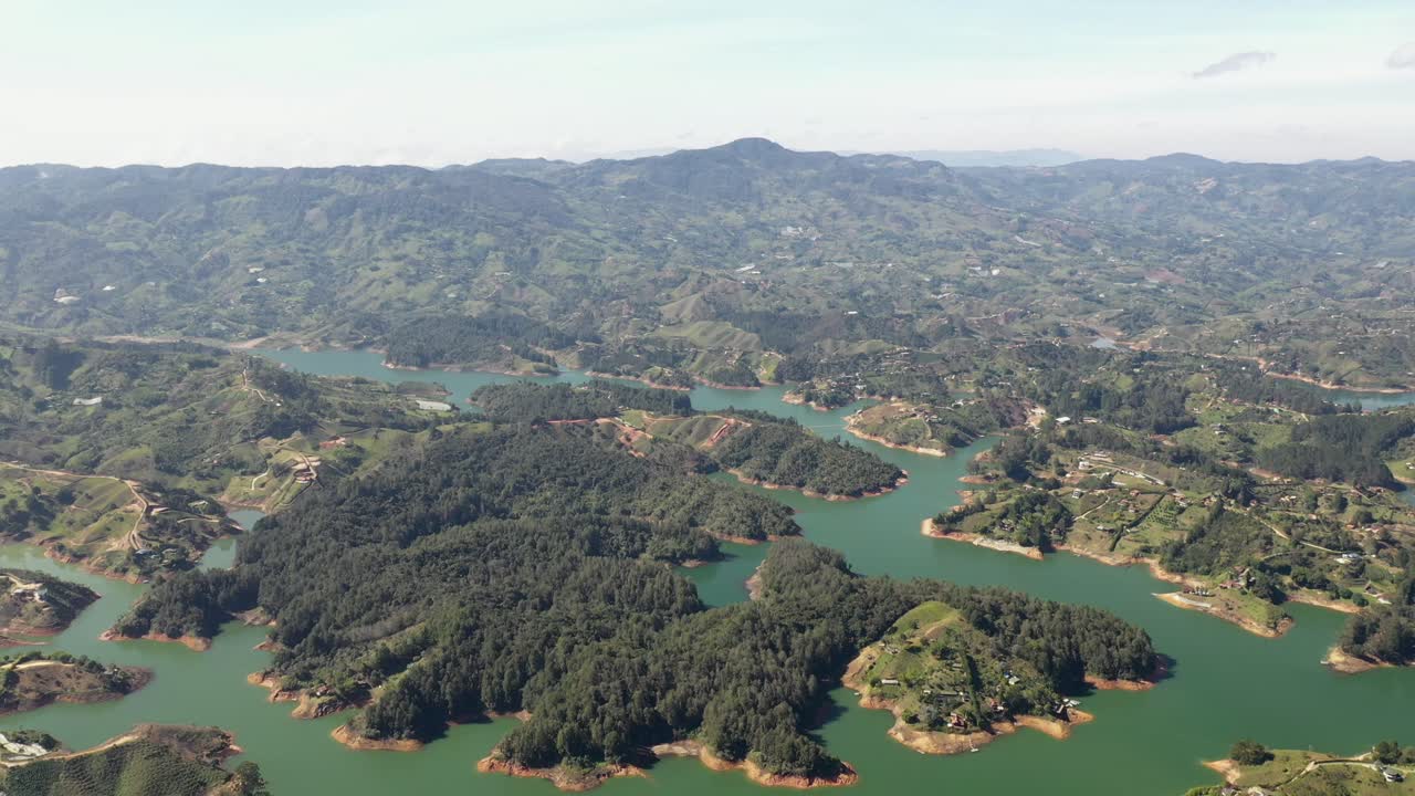 Cinematic Tilt Up Aerial Shot of El Peñol Rock Revealing Guatapé Reservoir