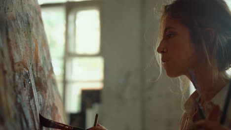 woman painting while smoking at workplace