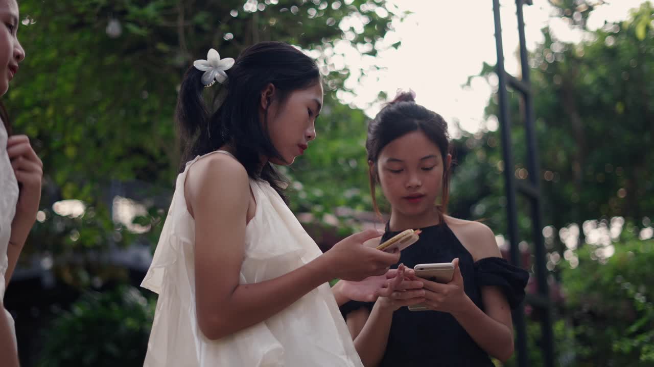 Teenagers using smartphones outdoors