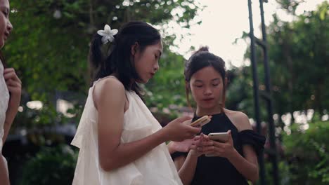 teenagers using smartphones outdoors